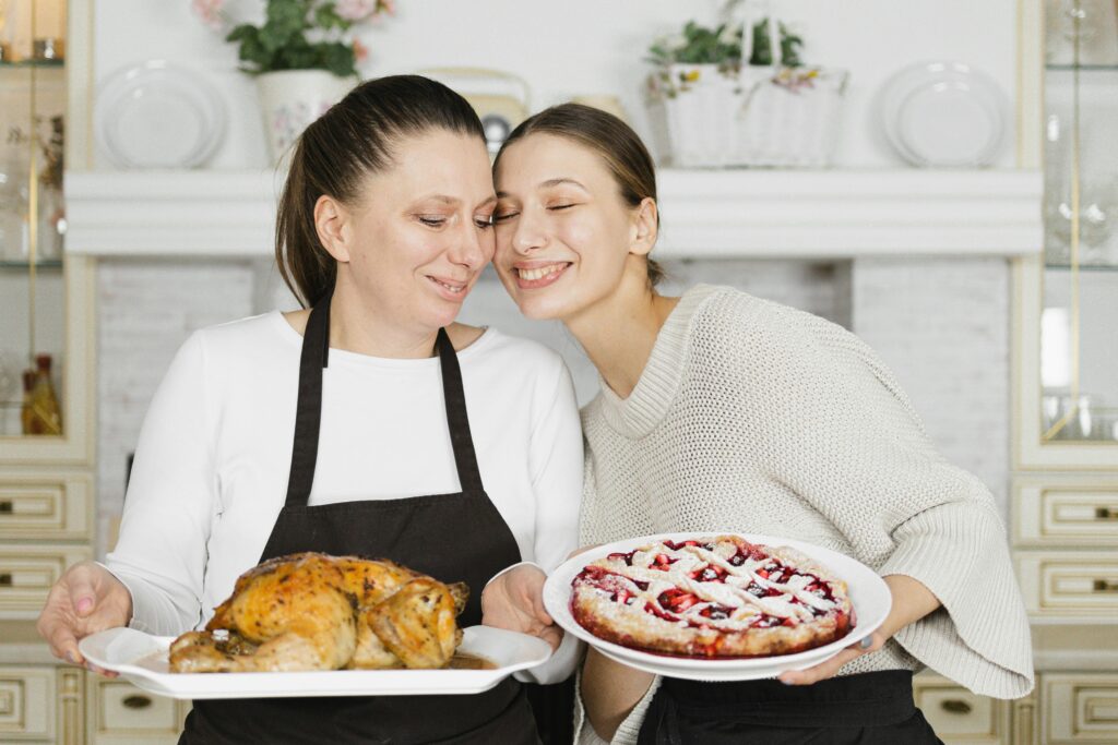 A joyful scene of a mother and daughter bonding while cooking a meal together in their home kitchen.
